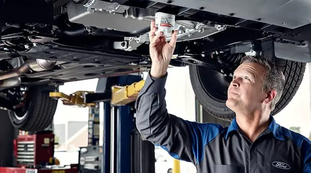 man changing oil
